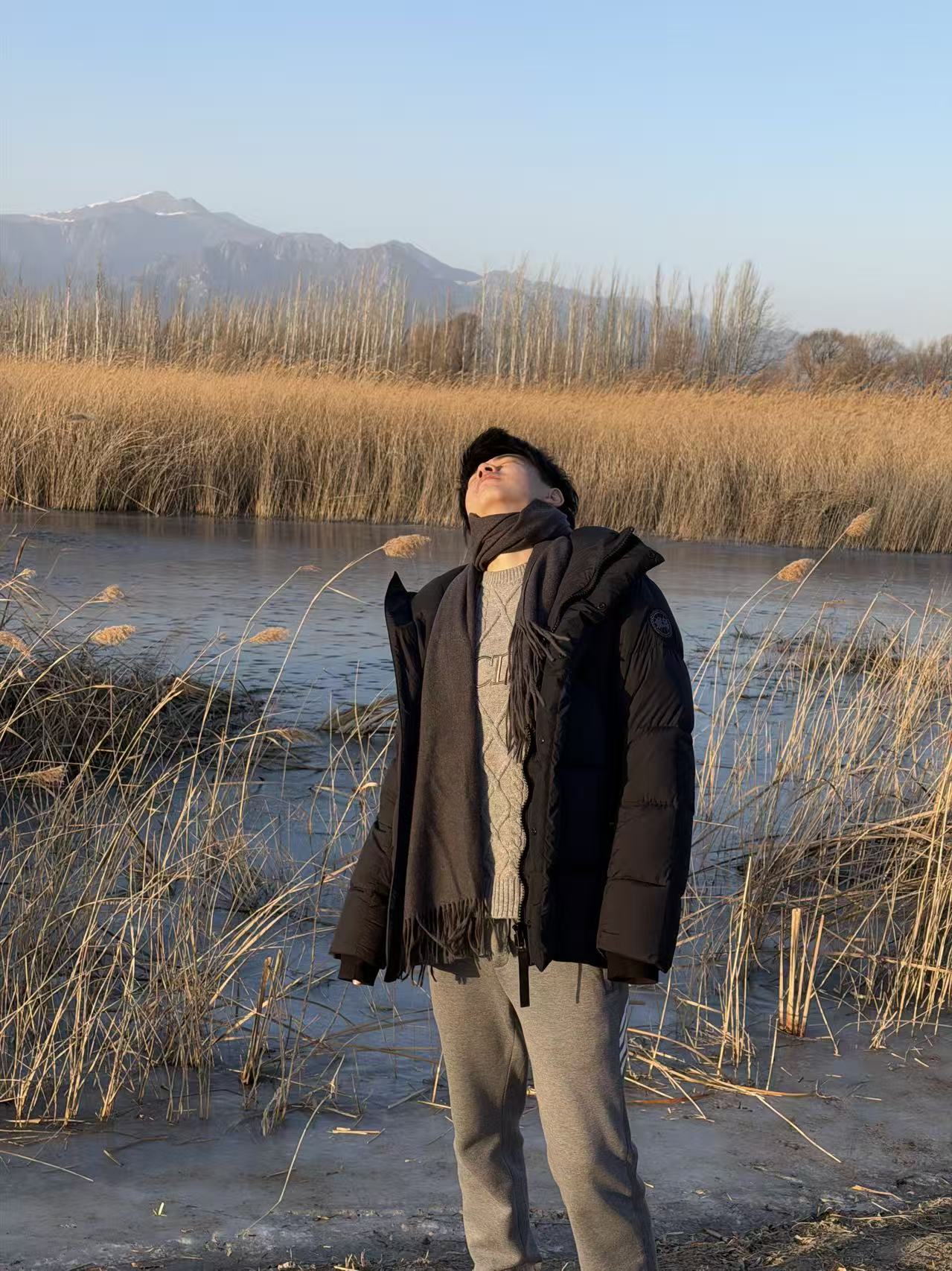 Zirui Zou outdoors beside a lake
